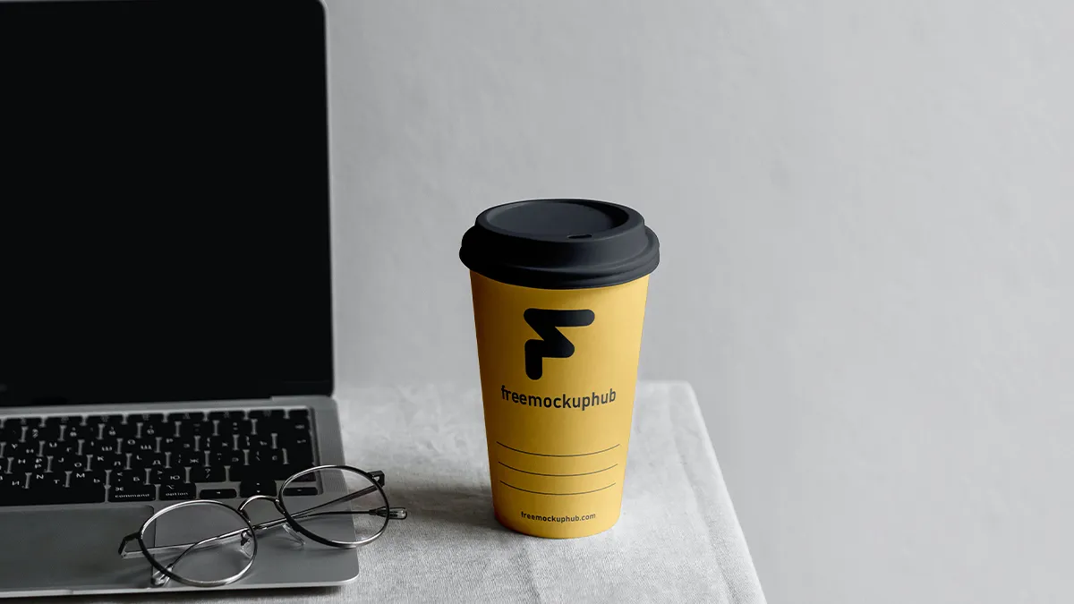 Free Paper Coffee Cup with MacBook Mockup